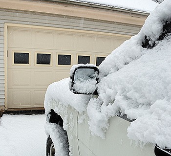 Snowy car in driveway