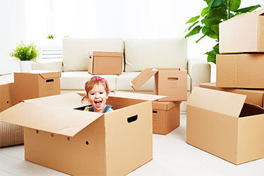 Toddler with moving boxes - Moving tips for parents