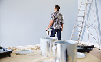 Man painting walls of home