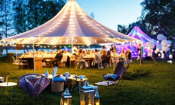 Tent and guests at an outdoor event.