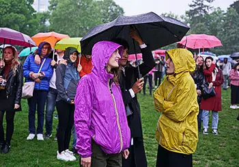 People at outdoor event while raining 